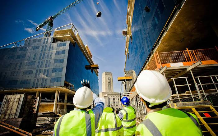 Crew reviewing tower construction on site