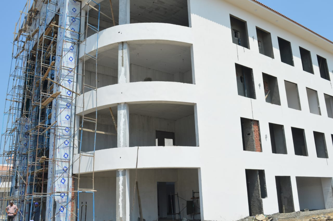 White facade building under scaffolding