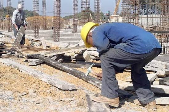 Worker preparing formwork timber